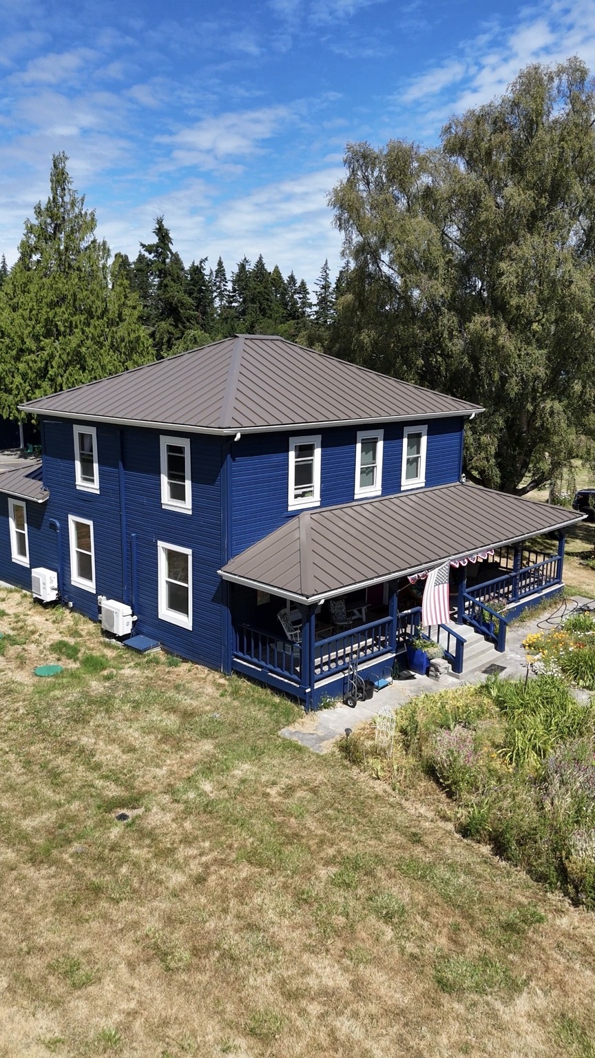 Wind Proof Roofing’s completed Nu-Ray NRM-1000 standing seam metal roof in Dark Bronze on an Oak Harbor home